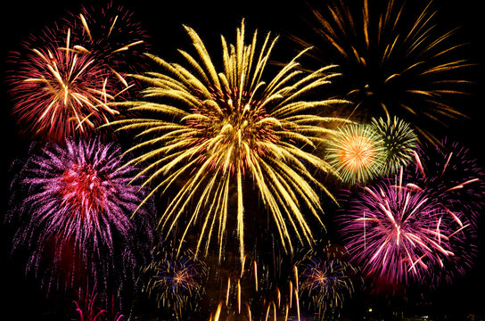 Colorful fireworks celebration on dark background.