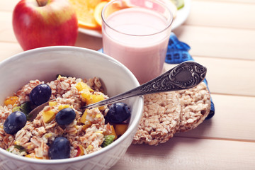 Tasty oatmeal and fruits on wooden background. Healthy eating concept.