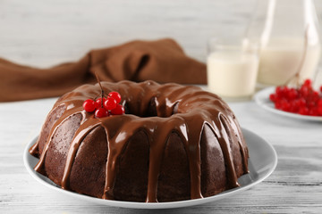 Chocolate cake with a bottle of milk on a table