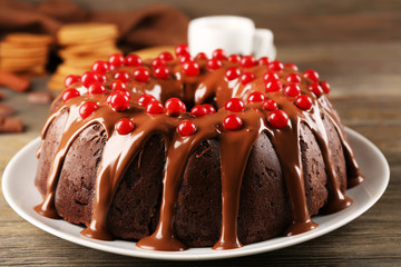 Chocolate cake with snowball tree berries on a table