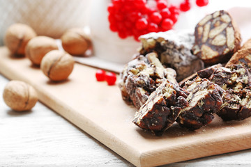 Chocolate salami with walnuts and red berries, close up