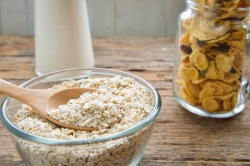 Cup of rolled oat flakes oatmeal on old wooden table