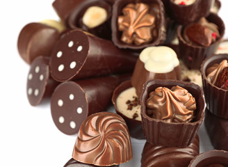 Assorted chocolate candies on white background