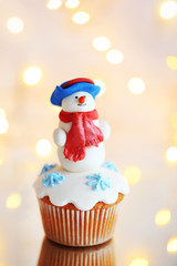 Christmas cupcake with lights on background