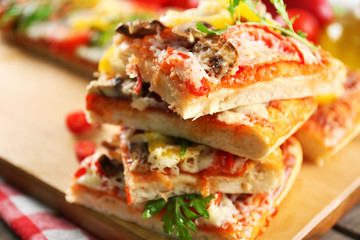Pieces of delicious pizza on the table, close-up