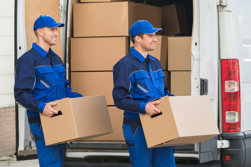 Delivery Men Carrying Cardboard Boxes