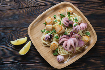 Spaghetti with seafood on a bamboo tray, view from above