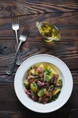 Salad with smoked octopus meat, potato and parsley, top view