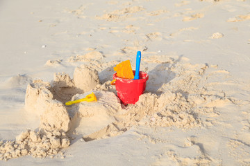 kids toys on white sand beach