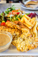 deep-fried fish steaks with almond flakes and friend fried
