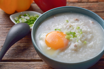 Thai chinese asian rice porridge with pork and egg  in  bowl, co