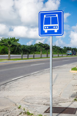 American road public bus stop sign at street road