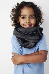 Smiling young kid in white studio