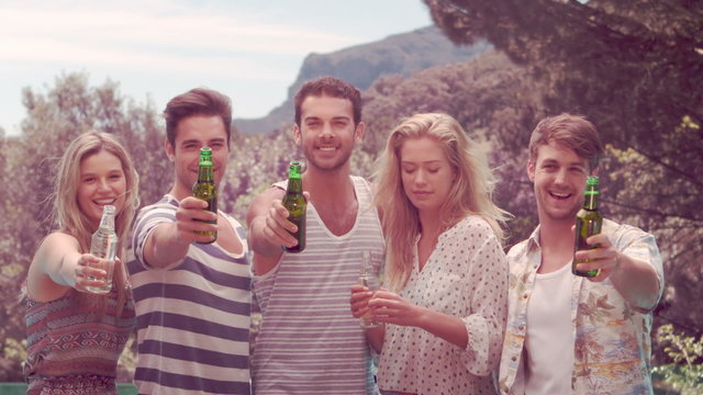 Happy friends holding beer bottles