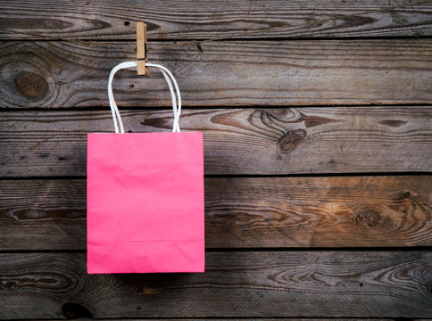 pink Shopping bag on a wooden background, sale, purchase