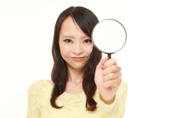 Japanese woman with a magnifying glass 