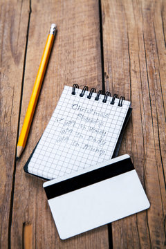 note and pencil, a shopping list for the holidays, credit card