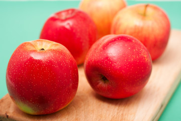 Red apples on cut board