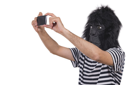 Gorilla man taking photos with his phone.