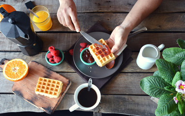 overhead photograph of person with breakfast waffles with marmal