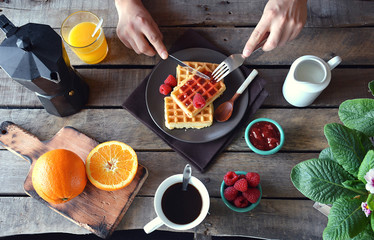 overhead photograph of person with breakfast waffles with marmal