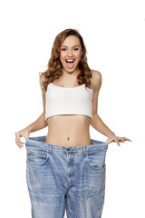 happy young woman posing with big pants
