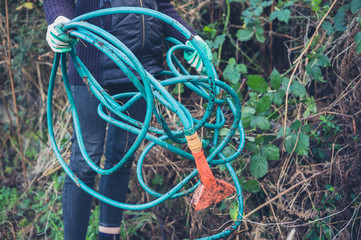 Woman holding garden hose