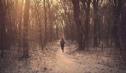 Man running in the winter forest