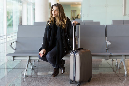 Attractive woman waiting for flight at the airport in winter