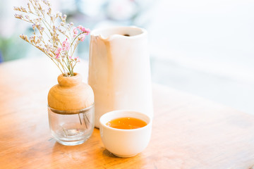 Cup of hot tea on wooden table , soft focus