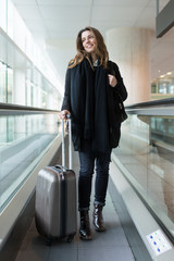 Attractive woman arriving at the airport in winter