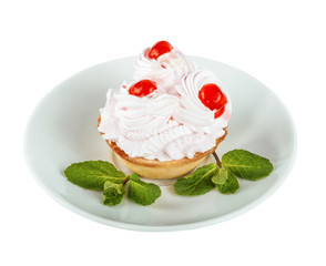 Cream cake with cherry on a white saucer, isolated on the white