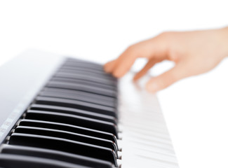 Fototapeta na wymiar Hand and piano keyboard on white background