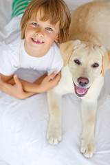 kid are playing with dog at home 