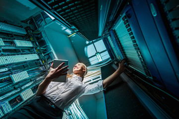 Young engineer businesswoman in server room