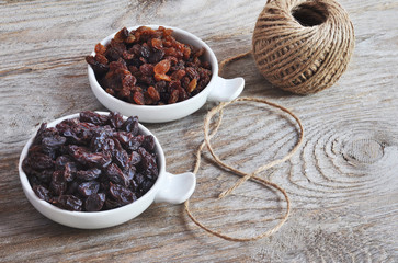 Dried raisins Turkish and Spanish (Malaga). Turkish raisins, Sultan raisins pitted . Raisins from Malaga with stones. Dried raisins on the wood backgraund