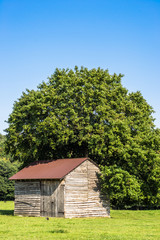 Obraz premium Landscape of rural barn for hay on a meadow