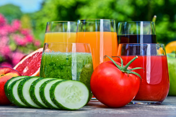 Glasses with fresh organic detox juices in the garden