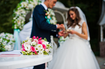 Happy groom and bride on wedding ceremony outdoor