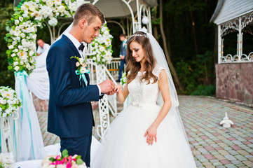 Happy groom and bride on wedding ceremony outdoor