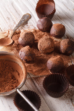 chocolate truffles sprinkled with cocoa powder close-up. Vertical
