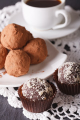 Delicious chocolate truffles and coffee close-up. vertical
