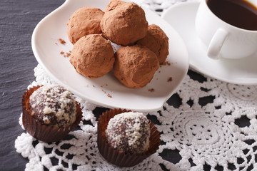 Gourmet food: chocolate truffles and coffee close-up. Horizontal

