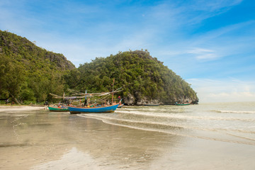Fototapeta na wymiar Samphraya Beach, fishing boat parked on beach, background is blue sky