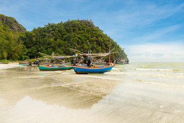 Fototapeta na wymiar Samphraya Beach in Thailand, fishing boat parked on beach, background is blue sky