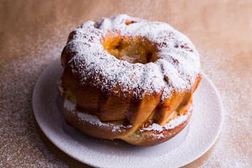 yeast cake with icing sugar on a plate