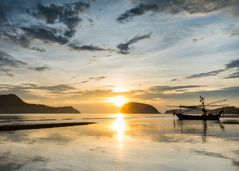 Samroiyod Beach, Thailand, fishing boat parked on the beach,  background is twilight sky at sunrise time with reflection sky