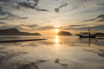 Samroiyod Beach, Thailand, fishing boat parked on the beach,  background is twilight sky at sunrise time with reflection sky