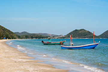Fototapeta na wymiar Samroiyod Beach, fishing boat parked on beach, background is blue sky