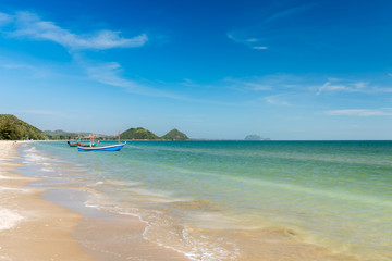 Samroiyod Beach, fishing boat parked on beach, background is blue sky